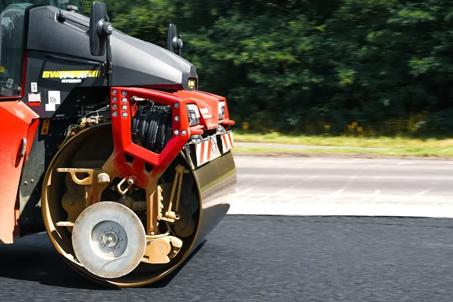 Tandem roller compacting a freshly laid asphalt mat